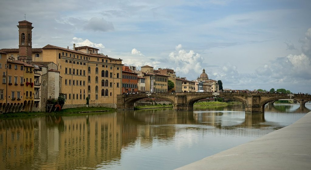 The Arno river and Ponte Santa Trinita under a cloudy sky